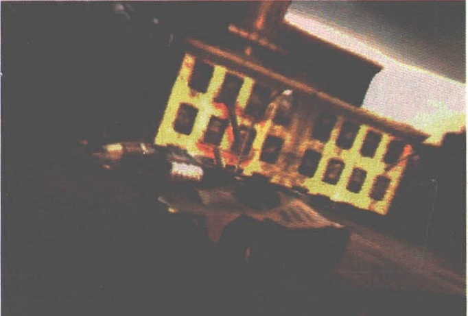 In-game close-up of a car's yellow-lit undercarriage/engine detail